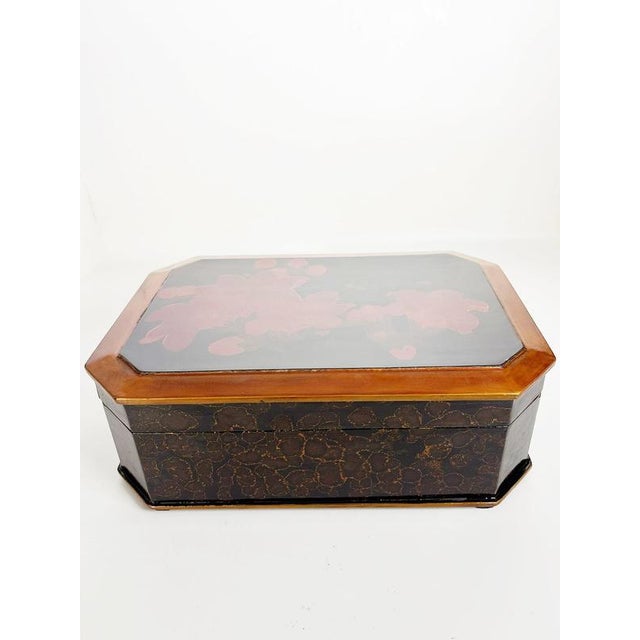 Elegant large lacquered decorative box from 1970s France, featuring a sophisticated combination of deep black and warm...