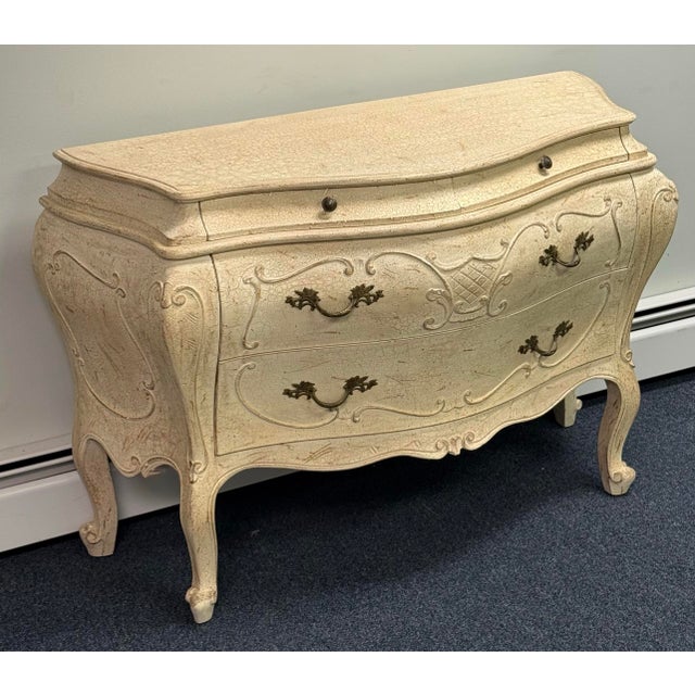 Beautifully crafted in Italy, this exquisite bombe chest features graceful curves, ornate Rococo-inspired detailing, and a...