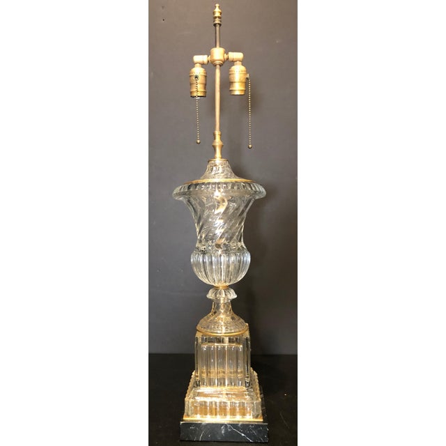 Baccarat spiral urn form table lamp. Baccarat style urn or vase form lamp on square black veined marble base with subtle...