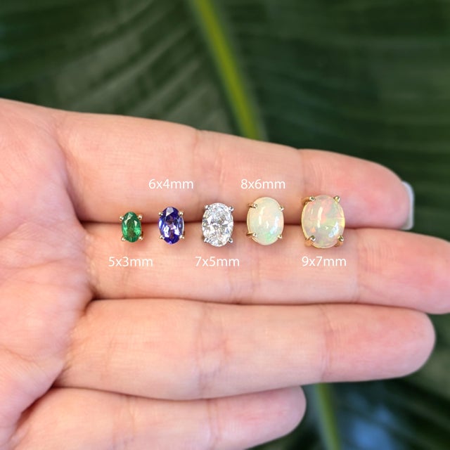 A matched pair of natural peridots glows in a fresh, lively green in these solid 14K gold four-prong stud earrings, each...