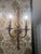 Gorgeous pair of French gilt bronze or brass double-arm wall sconces. These vintage Louis XVI style sconces feature a...
