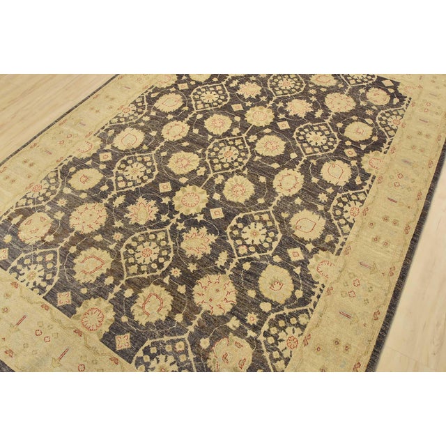 A traditional Ziegler rug hand-knotted with fine wool on a cotton foundation. This rug features a botanical design set...