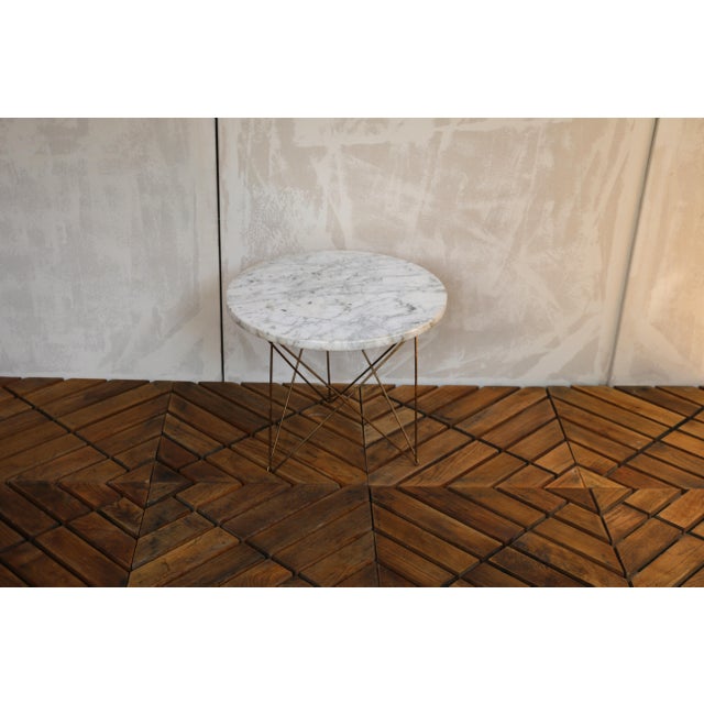 Wonderful vintage side table featuring a marble top and a distinctive "Eiffel" style tripod wire base, design aesthetic of...
