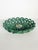 An elegant glazed ceramic fruit basket featuring an openwork structure of twisted motifs that create a delicate, plant-...