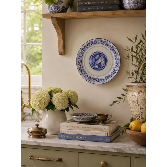 A handsome late 20th-century Italian faience wall plate in the Deruta tradition, hand painted in cobalt blue with a...