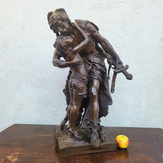 Large and beautiful bronze with a brown patina representing a valiant Gallic warrior embracing a child This sculpture with...