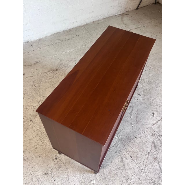 Newly refinished walnut and brass sideboard by Statton Furniture, featuring divided drawers and open storage cabinetry. In...