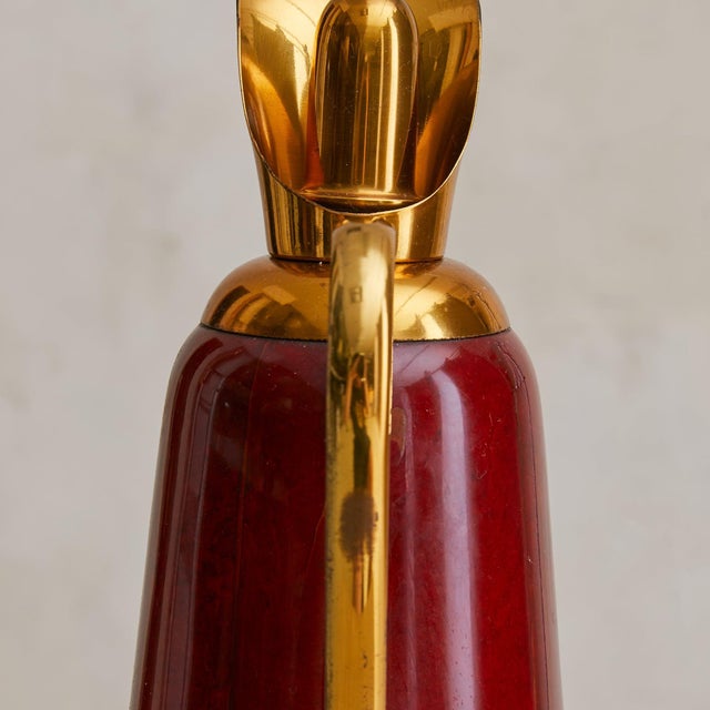 A 1960s Italian cocktail set by Aldo Tura for Macabo, comprising a tall pitcher, cocktail shaker, and ice bucket with a...