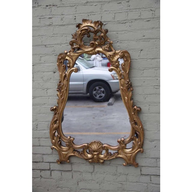 19th century carved giltwood Rococo style mirror with acanthus leaves and carved shell design.