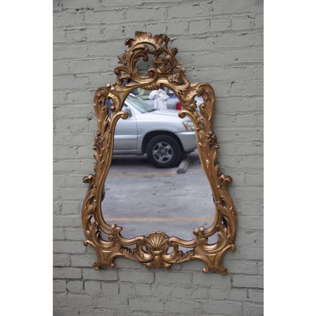 19th century carved giltwood Rococo style mirror with acanthus leaves and carved shell design.