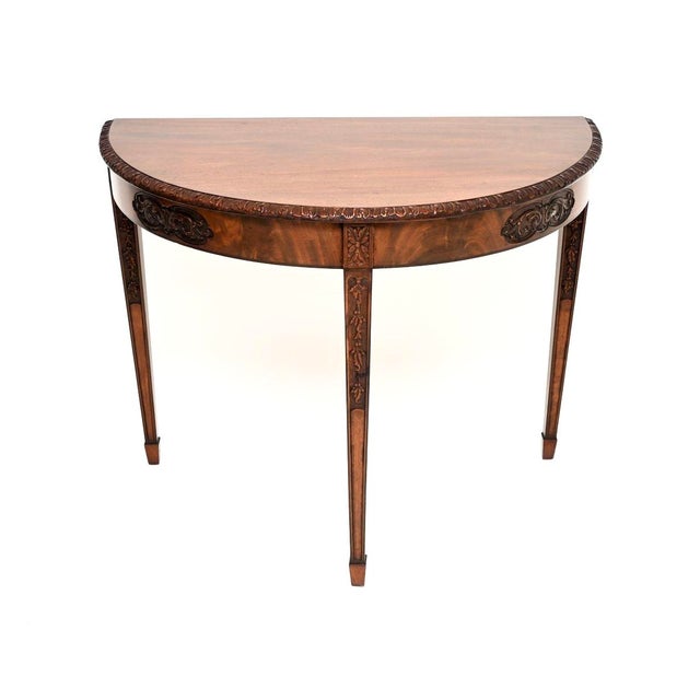 A wonderful antique carved console table, made in England and dating from around the 1890-1900 period. It is of fine...