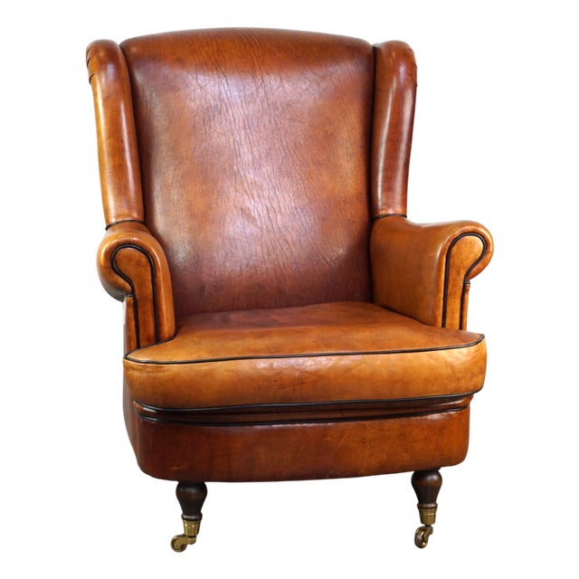 Subtle and Well-Maintained Sheep Leather Armchair on Brass Front Wheels For Sale
