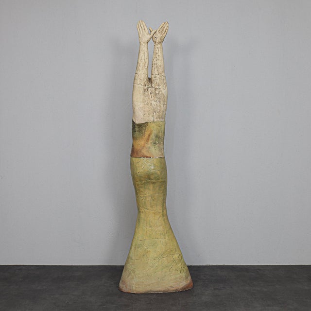 A powerful and elongated ceramic sculpture by dutch artist sjer jacobs, created in the 1990s. The figure is depicted...