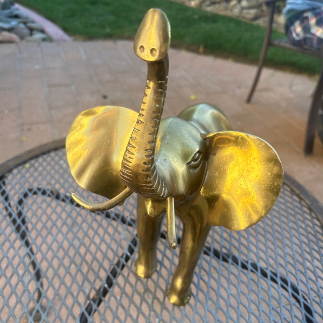 MidCentury Large Brass Elephant that has his ears out and his trunk up. They do not make them heavy and solid like this...