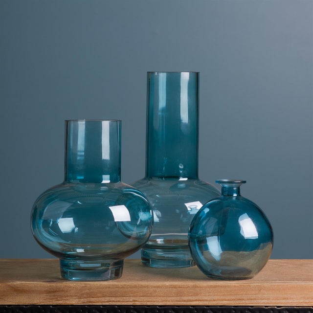 Elevate your space with this charming set of Blue Glass Bubble Vases. Crafted from cool-toned glass, these 5.5" decorative...