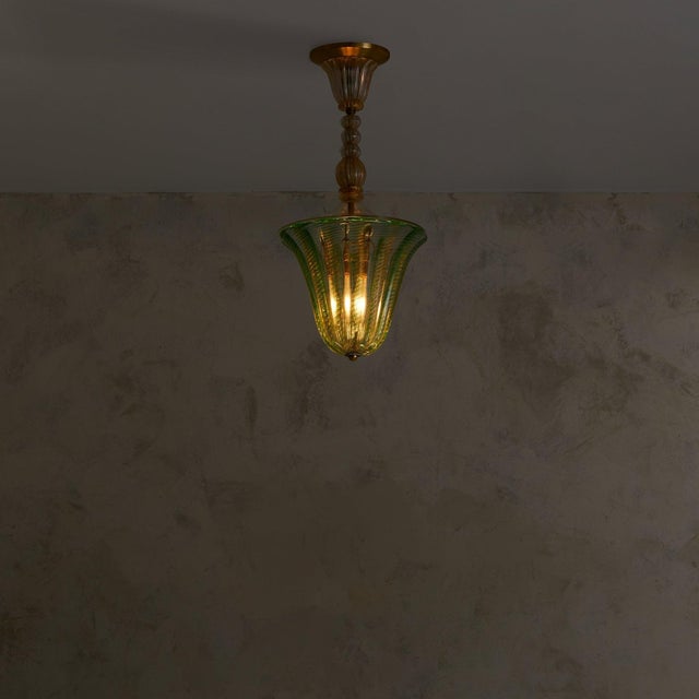 A rare Art Deco green Murano glass pendant attributed to the esteemed Barovier &amp; Toso atelier in the 1950s. The flared...