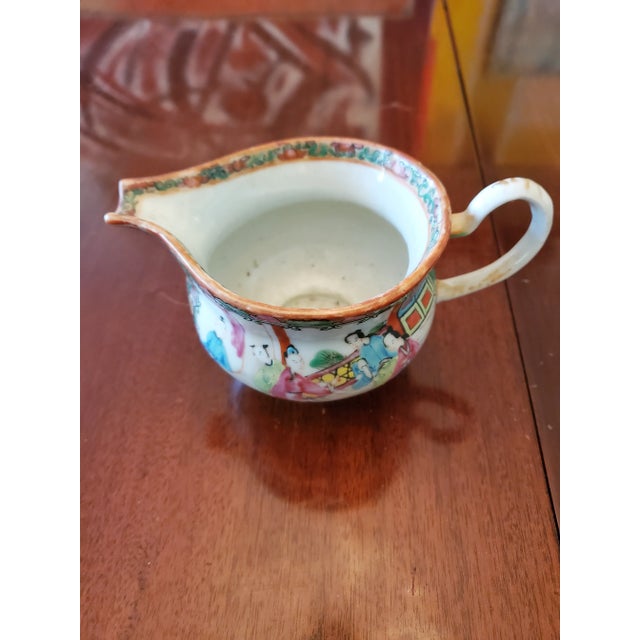 An original 200 years old Chinese porcelain hand painted with raised enamel decoration. Stylized handle with an...