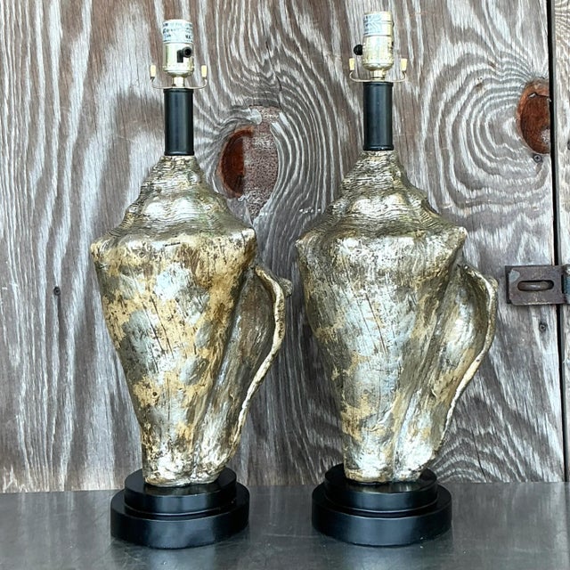 The Vintage Coastal Metallic Conch Shell Lamps are striking decorative pieces that capture the essence of seaside charm...