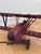 This large decorative airplane is a handmade folk art biplane model from Western Europe, dating to the 1930s. It is made...