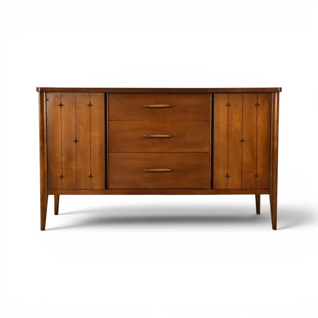 This 1960s Broyhill Saga buffet credenza carries the collection's signature incised star motif, cut into the vertical...