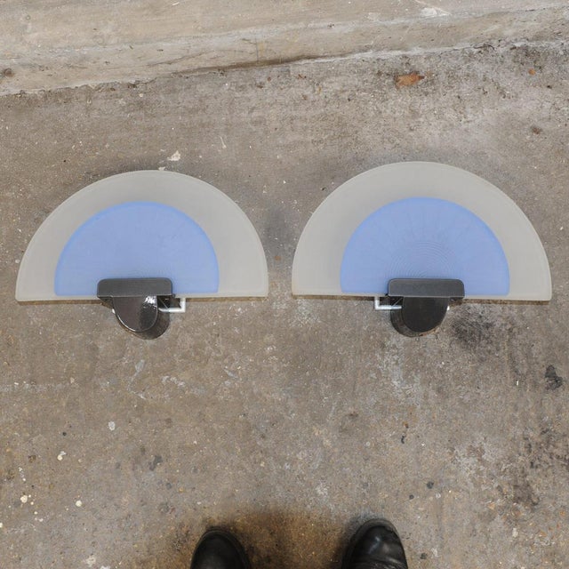 A pair of "diva" wall lamps (or sconces), designed in 1987 by ezio didone for the italian lighting manufacturer arteluce....