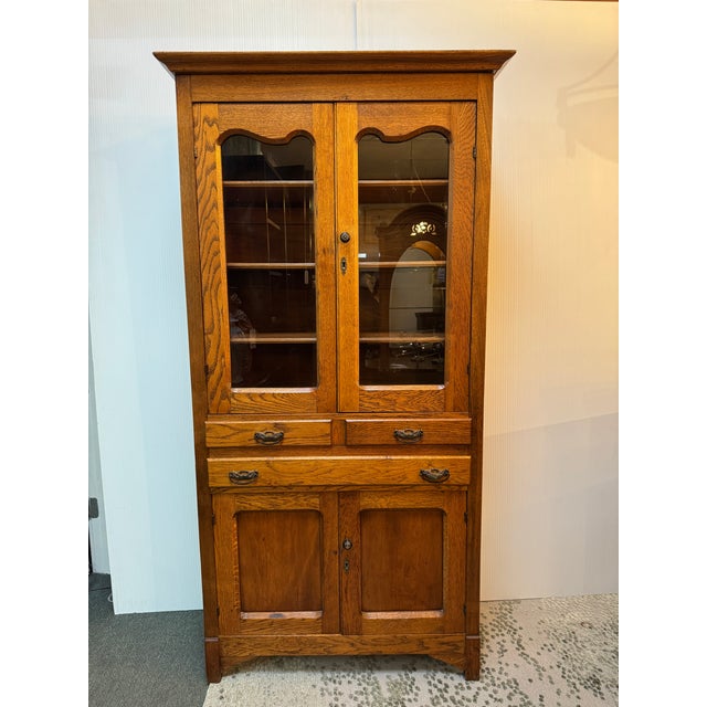 Design Plus Gallery presents an Oak Wood China Cabinet. The vintage cabinet will warm your home with its honey brown stain...