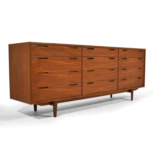 Designed by Ib Kofod-Larsen for Brande Møbelfabrik, this teak 12 drawer cabinet is beautifully constructed with dove-...