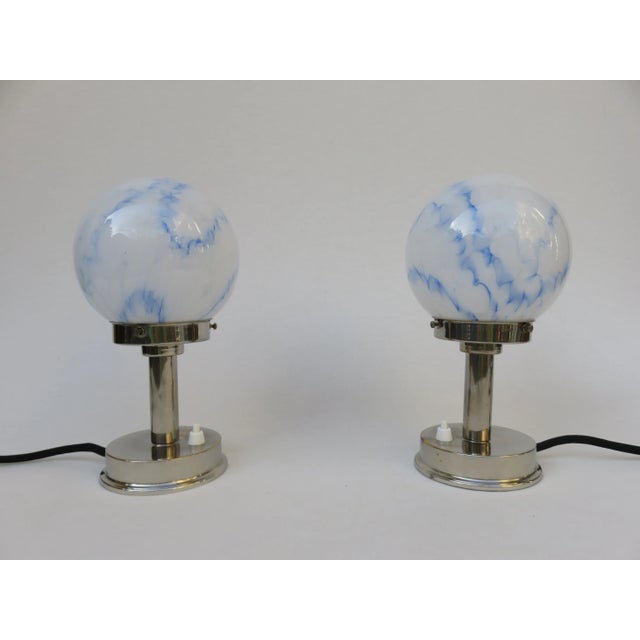 Small pair of table lamps e.g. for a sideboard, armoire or bedside tables from the Art Deco period, a nickel-plated base,...