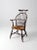 This is an antique Windsor arm chair with rush seat. A exceptional example of the comb back Windsor chair features an...