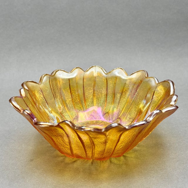 Bring a radiant burst of retro charm to your home with this striking marigold carnival glass bowl, featuring a highly...