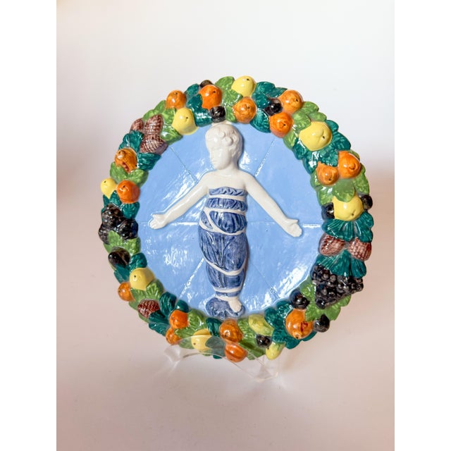 Vintage Mid Century Italian Ceramic Della Robbia style sculptural wall plaque. This stunning piece features rich color and...