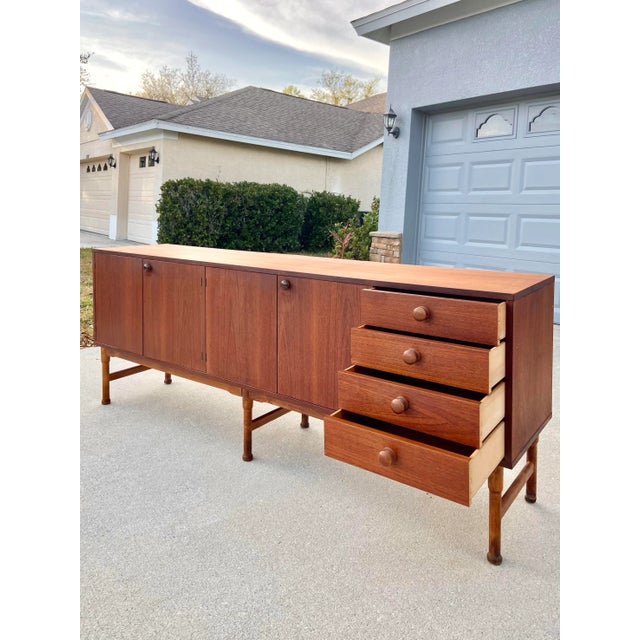 Rare Mid Century Teak Danish Style Credenza. Such a show stopper! This piece is stellar with its slim look and all the...