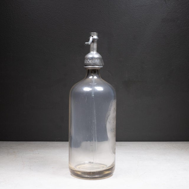 ABOUT Antique heavy glass mineral water seltzer siphon bottle with chrome plated dispensing head. Acid-etched lettering on...