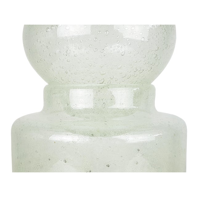 This big bottle was produced in Italy in the 1960s. It is made from a clear Murano glass with air bubbles inclusions which...