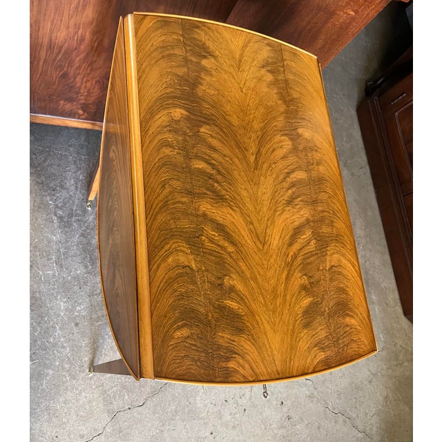 Elegant vintage drop-leaf table by Bollier & Company by Decca, featuring a highly figured and bookmatched crotch walnut...