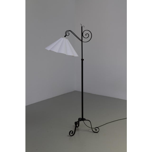 A sculptural handcrafted floor lamp in black painted wrought iron with a white fabric shade. Very beautiful and elegant...