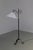 A sculptural handcrafted floor lamp in black painted wrought iron with a white fabric shade. Very beautiful and elegant...
