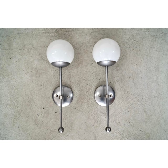 Pair of original Michele Varian globe sconces for sale. Mid century style and design, and retail $840 each brand new....