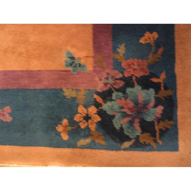 Antique Art Deco Small Scatter Size Wool Coral Rug, Circa Date: 1920s. This exquisite textile captures the vibrant,...