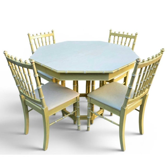 A refined Hollywood Regency dining set by Thomasville, crafted in the late 20th century and finished in an elegant ivory...