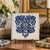 A classic Dutch Delft-style hand painted blue and white porcelain tile featuring an intricately rendered heraldic coat of...