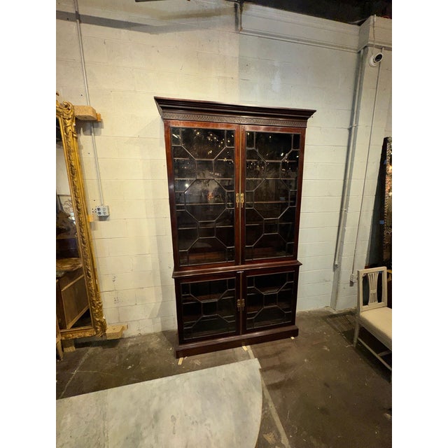 The 19th c. English Mahogany Display Cabinet is a handsome piece of furniture that exudes elegance and sophistication....