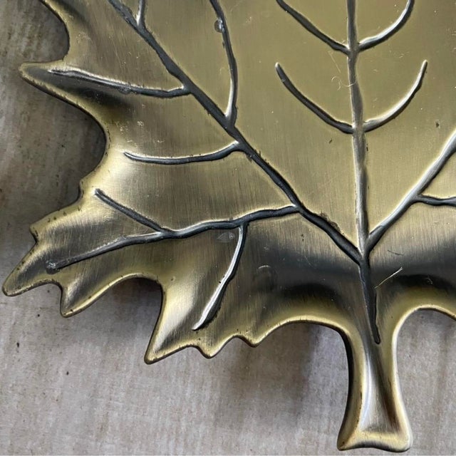 Gold brass vintage metal maple leaf trinket dish, frequently used as a decorative catch-all tray for jewelry, coins, or...