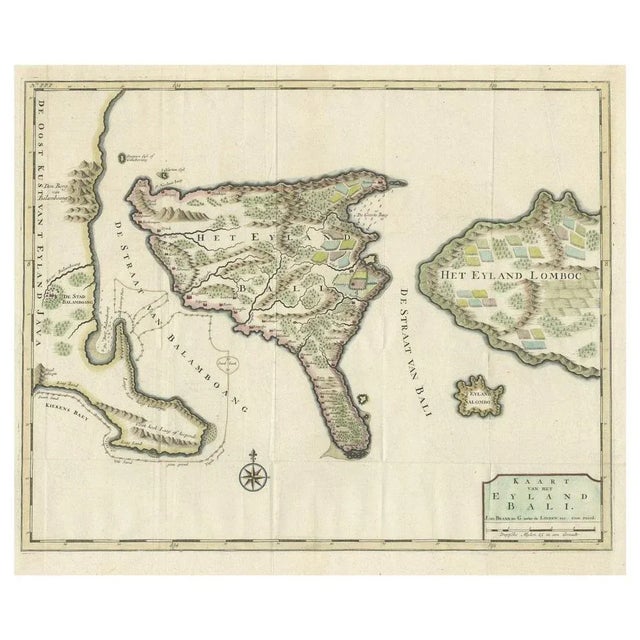 This antique map is a detailed 18th-century chart of the island of Bali, one of the many islands of Indonesia, with an...