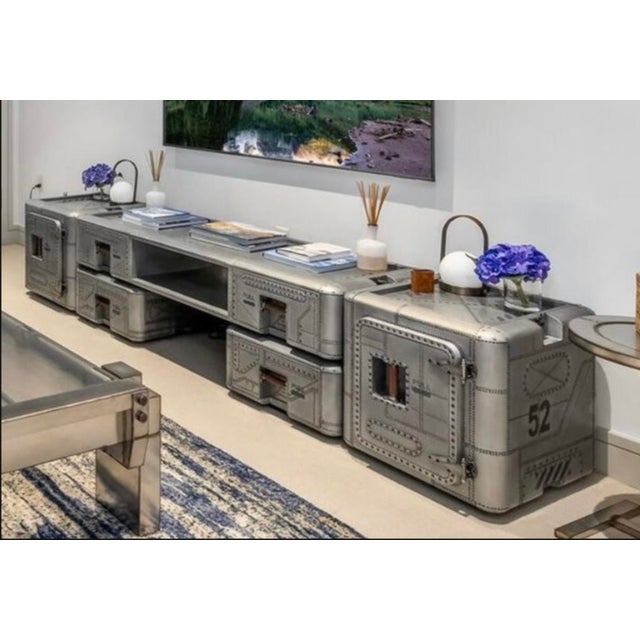 Elevate your living space with the striking Timothy Oulton Cobra Media Unit, a unique piece inspired by military storage...