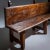 Long bench made of solid wood with a beautiful patina and iron rivets. The bench stands on three legs, with the backrest...