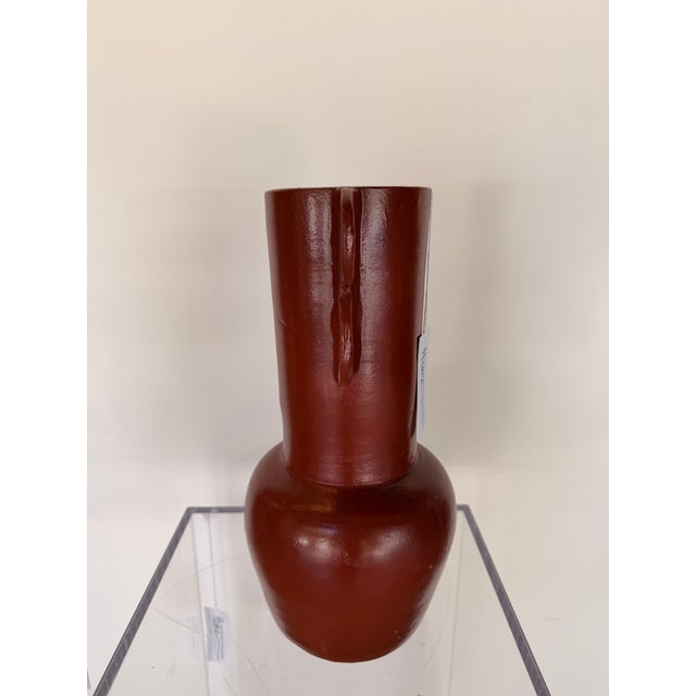 Contemporary decorative sculpture crafted from terracotta, featuring a rich earthy glazed finish and a bold, organic...