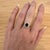 A sapphire shines in a rich blue at the centre of this solid 14K yellow gold ring, encircled by fourteen earth-mined...