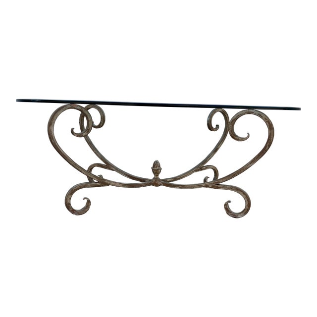 Vintage Hollywood Regency Style Coffee Table Featuring a Gold-Finished Wrought Iron Base With Scrollwork and an Oval Beveled Glass Top For Sale