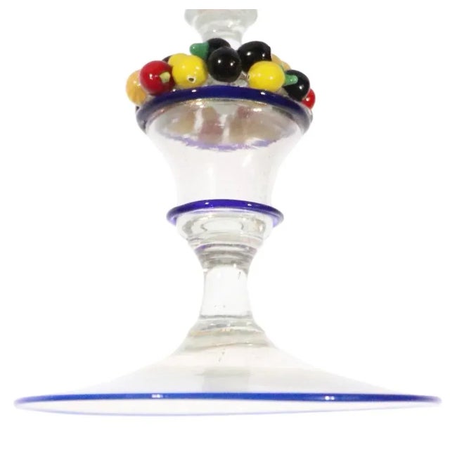 Impressive trumpet form art glass vase made in Murano, Italy having a basket of fruit incorporated in the stem. This...
